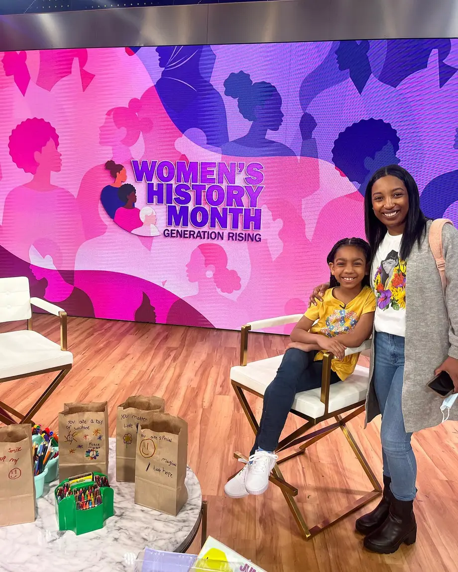Paris and her mom smiling on the Good Morning America set, next to paper care package bags with handwritten messages